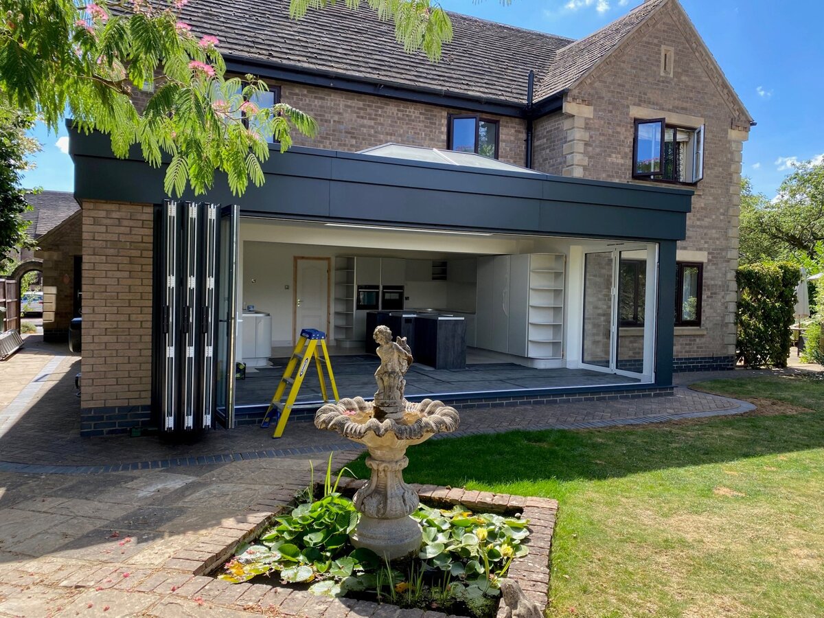 Finished extension with bifold doors open and kitchen visible