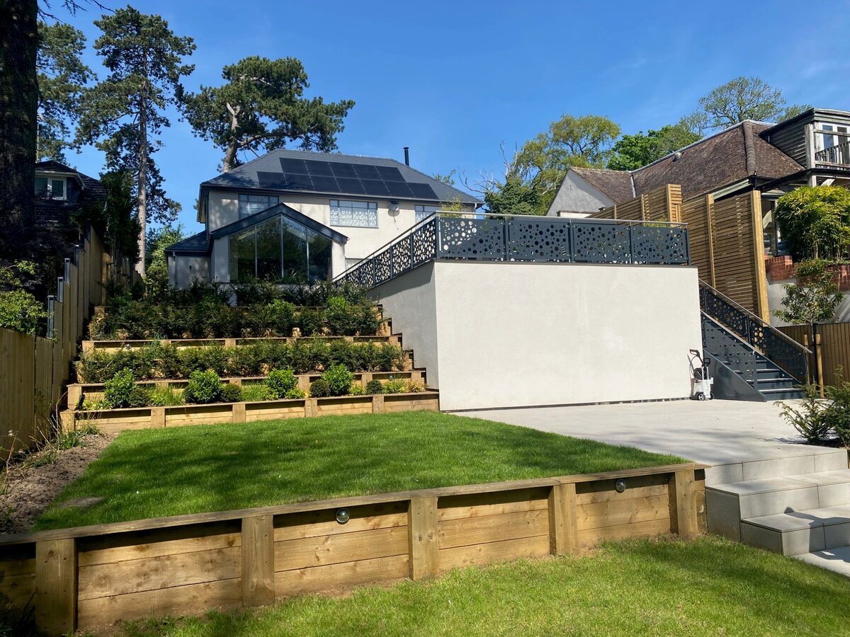 Rear of house with solar panels and landscaped terracing