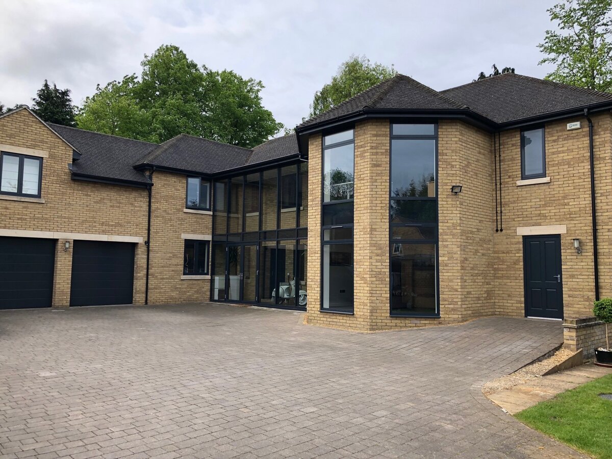 Major renovation after — glazed atrium, anthracite windows and block paving