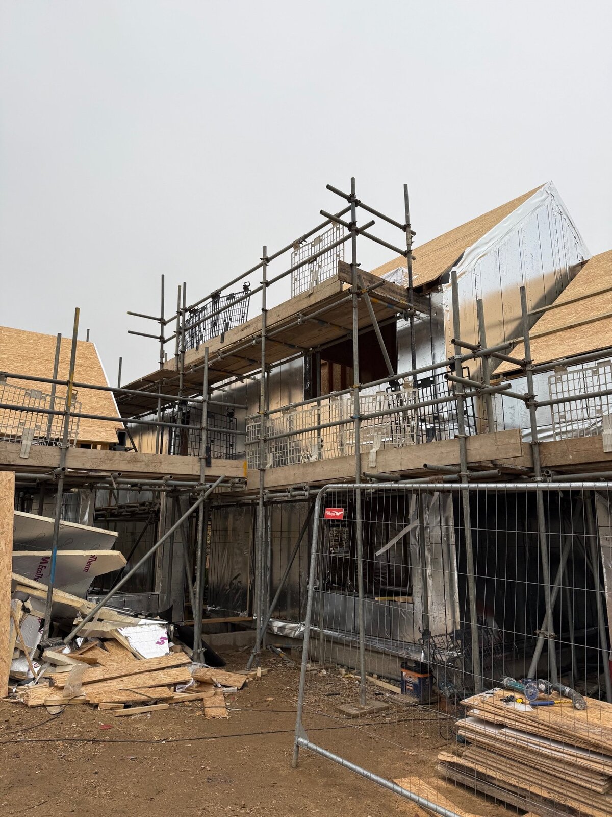 New build in progress with scaffolding and roof structure