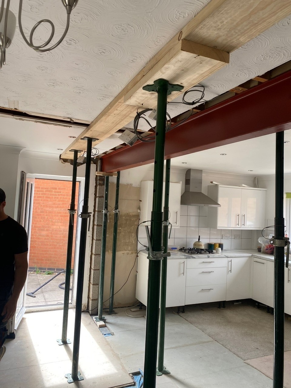 RSJ structural steel beam installation with acrow props in residential kitchen