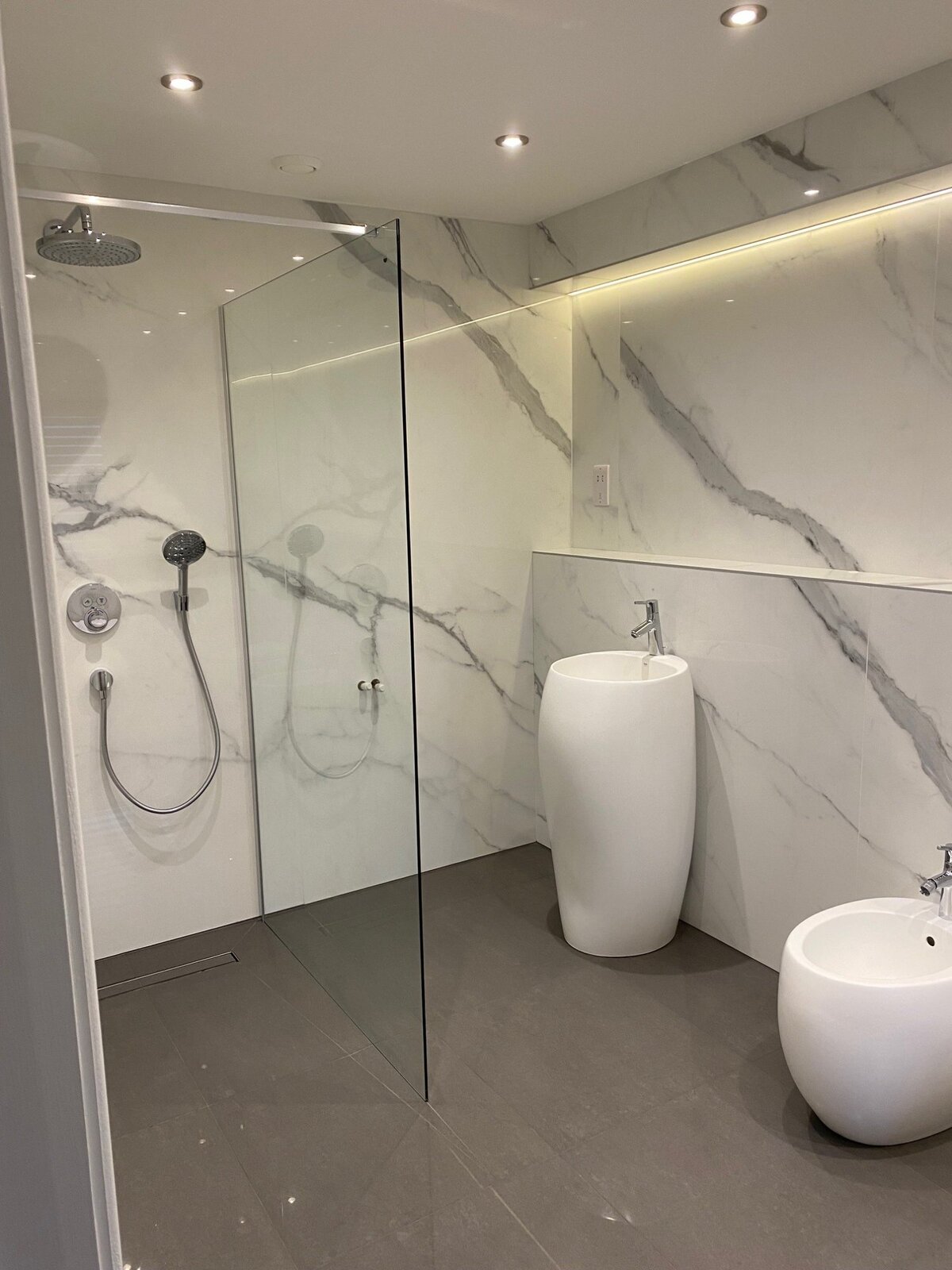 Porcelanosa wet room with frameless glass and rain head