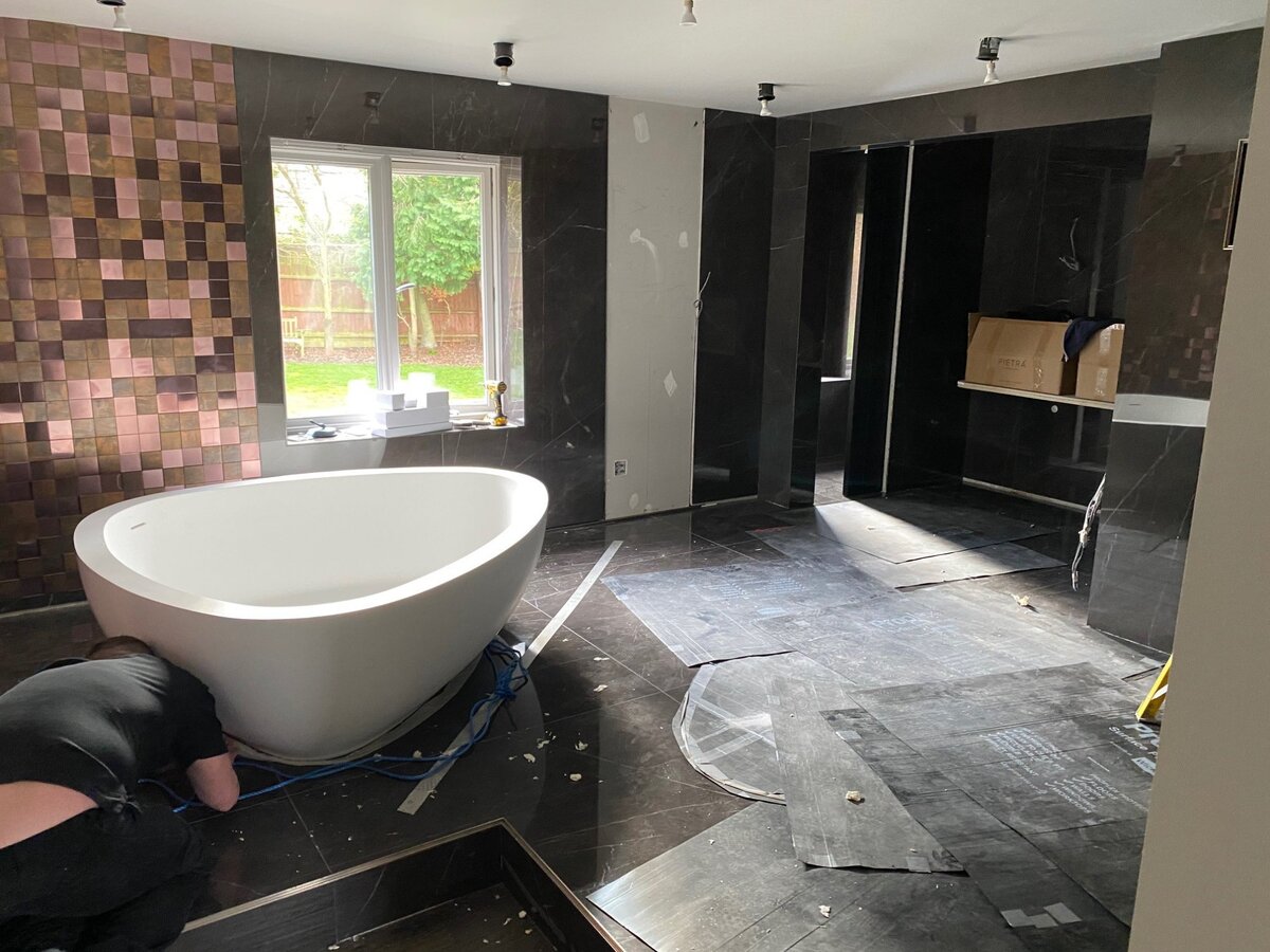 Copper mosaic feature bathroom being installed
