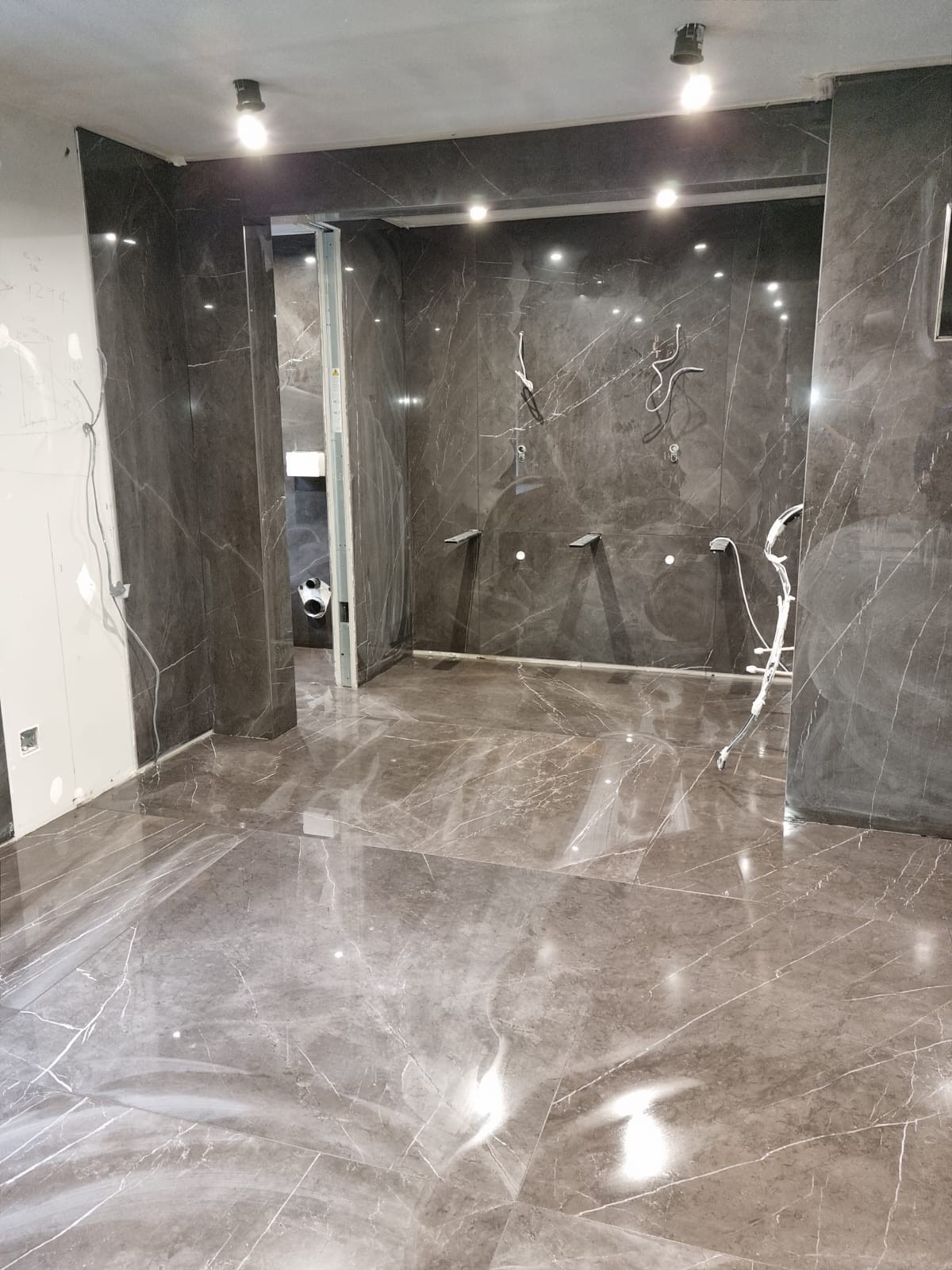 Feature bathroom overview with polished floor tiles and walk-in shower