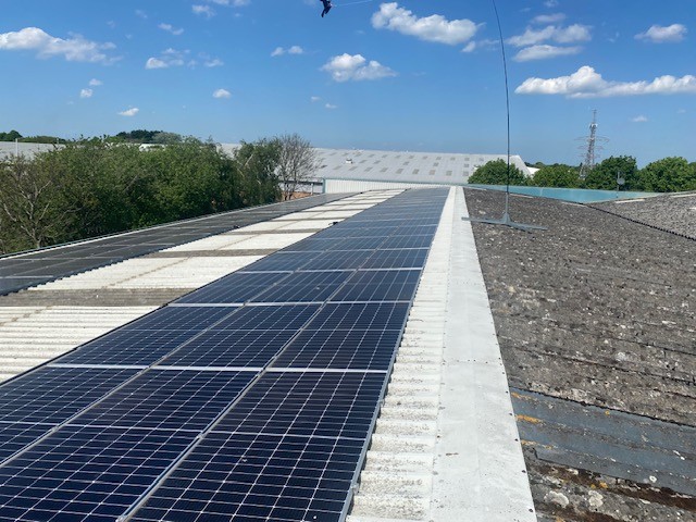 Large industrial solar PV array on warehouse roof